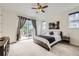 Main bedroom with neutral carpeting and a sliding glass door leading to a balcony at 1063 Sandstone Cir, Erie, CO 80516