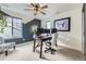 Home office with ceiling fan, dual monitors, and modern decor at 1063 Sandstone Cir, Erie, CO 80516