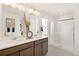 Modern bathroom featuring double sinks, a glass-enclosed shower, and ample natural light at 3347 Belleville Ridge Rd, Elizabeth, CO 80107
