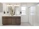 Bright bathroom with a double vanity, walk-in shower, and contemporary fixtures at 3347 Belleville Ridge Rd, Elizabeth, CO 80107