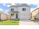 Inviting two-story home featuring a covered porch, well-maintained lawn, and an attached two-car garage at 3347 Belleville Ridge Rd, Elizabeth, CO 80107