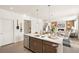 Open-concept kitchen with stainless steel appliances, gray cabinets and the living room in the background at 3347 Belleville Ridge Rd, Elizabeth, CO 80107