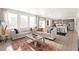 Open concept living area featuring a large sofa, natural light, and a seamless flow to the kitchen at 3347 Belleville Ridge Rd, Elizabeth, CO 80107