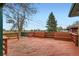 Backyard deck overlooking green lawn and some landscaping at 13621 E Center Ave, Aurora, CO 80012