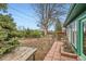 Landscaped backyard featuring brick walkways and a wooden picnic table at 13621 E Center Ave, Aurora, CO 80012