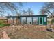 Backyard featuring a green exterior, brick garden edging, and lawn at 13621 E Center Ave, Aurora, CO 80012