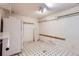 Unfinished basement with black and white floors and storage shelving at 13621 E Center Ave, Aurora, CO 80012