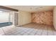 Unfinished basement area with tile floors and an unfinished wood accent wall at 13621 E Center Ave, Aurora, CO 80012