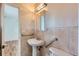 Small bathroom with accessible features including grab bars and a pedestal sink, offering convenience and safety at 13621 E Center Ave, Aurora, CO 80012