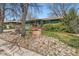 Ranch home featuring a well-kept lawn, rock garden, mature landscaping, and covered porch at 13621 E Center Ave, Aurora, CO 80012