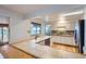 Kitchen with tile countertops, breakfast bar, stainless steel appliances, and hardwood floors at 13621 E Center Ave, Aurora, CO 80012