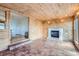 Bright sun room with wood-paneled walls, tile floor, and fireplace creating a cozy atmosphere at 13621 E Center Ave, Aurora, CO 80012