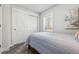 Cozy bedroom features a grey carpet, closet with sliding doors, and a sunny window at 20 S Harlan St, Lakewood, CO 80226