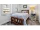 Comfortable bedroom featuring a bed, a side table, and a large window at 20 S Harlan St, Lakewood, CO 80226