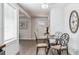 Inviting entryway with a glass table, gray wood flooring, and a decorative wall hanging at 20 S Harlan St, Lakewood, CO 80226