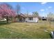Charming one-story home with white siding, a covered porch, and a well-manicured lawn at 20 S Harlan St, Lakewood, CO 80226