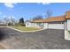 Well-maintained home with a manicured lawn, paved driveway, and an attached two-car garage at 20 S Harlan St, Lakewood, CO 80226