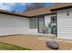 Inviting front porch with comfortable seating surrounded by decorative rock and green grass at 20 S Harlan St, Lakewood, CO 80226