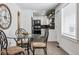 Eat-in kitchen with breakfast nook with seating, black appliances, and white cabinets at 20 S Harlan St, Lakewood, CO 80226