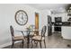 Bright eat-in kitchen with glass table, and white cabinets and stainless appliances at 20 S Harlan St, Lakewood, CO 80226