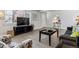 Open living room with a TV, wood floors, and comfortable seating for relaxation and entertainment at 20 S Harlan St, Lakewood, CO 80226