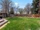 Large manicured backyard with grass and wooden fence at 2535 Leyden St, Denver, CO 80207