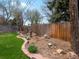Backyard landscaping features stone accents and wood fence at 2535 Leyden St, Denver, CO 80207