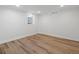 Basement area with hardwood floors, recessed lighting, and windows providing natural light at 2535 Leyden St, Denver, CO 80207