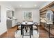 Bright dining room featuring a modern table set, accent wall, and plenty of natural light at 2535 Leyden St, Denver, CO 80207
