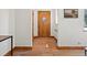 Traditional entryway featuring hardwood floors, white walls and a wooden front door at 2535 Leyden St, Denver, CO 80207