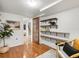 Versatile flex room with hardwood floors, built-in shelving, and a comfortable chair at 2535 Leyden St, Denver, CO 80207