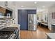 Well-equipped kitchen with stainless steel appliances, sleek countertops, and modern cabinetry providing ample storage and workspace at 2535 Leyden St, Denver, CO 80207