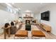 Inviting living room with a stone fireplace, comfortable seating, and a large screen TV for entertainment at 2535 Leyden St, Denver, CO 80207