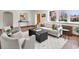 Inviting living room with hardwood floors, stylish furniture, and ample natural light from large windows providing a comfortable space at 2535 Leyden St, Denver, CO 80207