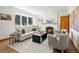 Bright living room with a fireplace, large windows, and comfortable seating area at 2535 Leyden St, Denver, CO 80207