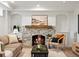 Cozy living room with a stone fireplace, comfortable seating, and a natural light at 2535 Leyden St, Denver, CO 80207