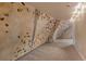 Spacious basement with textured climbing wall, featuring multicolored holds at 1304 5Th St, Golden, CO 80403