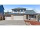 Charming two-story home boasts a brick and siding exterior, two-car garage, and manicured front yard at 1304 5Th St, Golden, CO 80403