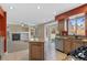 Spacious kitchen with an island, tiled floors, stainless steel appliances, and a view to the fireplace at 1304 5Th St, Golden, CO 80403
