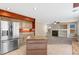 Kitchen with island featuring stainless steel appliances, cabinets, and view to fireplace at 1304 5Th St, Golden, CO 80403