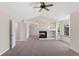 Spacious living room with fireplace, built-in shelving, ceiling fan, and neutral color palette at 1304 5Th St, Golden, CO 80403