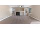 Bright living room features a cozy fireplace, built-in shelving, and neutral carpeting at 1304 5Th St, Golden, CO 80403