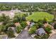 Aerial view of a neighborhood with mature trees, a large school, and green spaces at 9016 W Alabama Pl, Lakewood, CO 80232