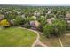 Aerial view showcases the home with lush greenery, lawn, and nearby park at 9016 W Alabama Pl, Lakewood, CO 80232