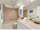 Bathroom featuring a bathtub, shower, and a large mirror above the sink at 9016 W Alabama Pl, Lakewood, CO 80232