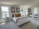 Bright bedroom featuring soft carpet, neutral decor, and ample natural light from two windows at 9016 W Alabama Pl, Lakewood, CO 80232