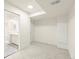 Bright bedroom featuring neutral carpet, a bathroom doorway, and light walls at 9016 W Alabama Pl, Lakewood, CO 80232