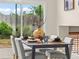 Dining table set in front of sliding glass doors leading to outdoor space and fenced backyard at 9016 W Alabama Pl, Lakewood, CO 80232