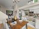 Open concept showcasing the dining area connecting to a modern kitchen and a cozy living space at 9016 W Alabama Pl, Lakewood, CO 80232