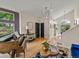 Bright entryway with hardwood floors, modern light fixtures, a piano, and views of the backyard at 9016 W Alabama Pl, Lakewood, CO 80232